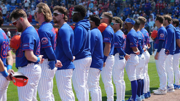 Feb 25, 2026; Port St. Lucie, Florida, USA;  The New York Mets line up for the national anthem before the game against the St. Louis Cardinals at Clover Park. Mandatory Credit: Jim Rassol-Imagn Images