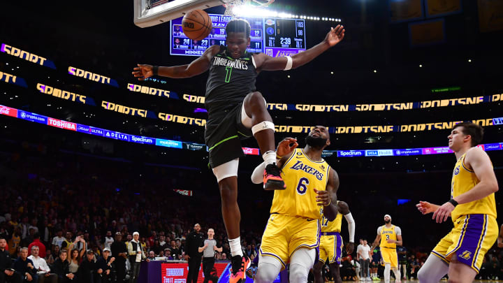 Apr 11, 2023; Los Angeles, California, USA; Minnesota Timberwolves guard Anthony Edwards (1) scores a basket ahead of Los Angeles Lakers forward LeBron James (6) during the second half at Crypto.com Arena. Mandatory Credit: Gary A. Vasquez-USA TODAY Sports