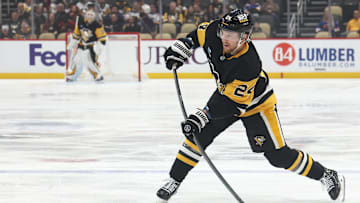 Mar 13, 2025; Pittsburgh, Pennsylvania, USA;  Pittsburgh Penguins defenseman Matt Grzelcyk (24) shoots the puck against the St. Louis Blues during the first period at PPG Paints Arena. Mandatory Credit: Charles LeClaire-Imagn Images