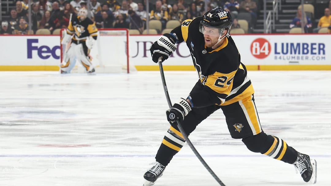 Mar 13, 2025; Pittsburgh, Pennsylvania, USA;  Pittsburgh Penguins defenseman Matt Grzelcyk (24) shoots the puck against the St. Louis Blues during the first period at PPG Paints Arena. Mandatory Credit: Charles LeClaire-Imagn Images
