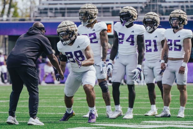 Scottie Graham puts his Husky running backs through a spring drill. 