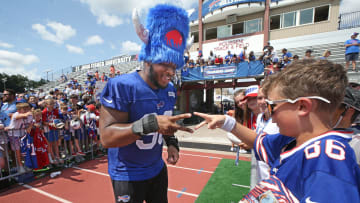 Bills defensive tackle DeWayne Carter looses a game of 'rock, paper, sissors' to fan Isaac Howlett, 11, Rochester, as he signs autographs at the end of day three. The pair were playing for Carter's wristbands, which Howlett won.