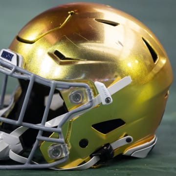 Jan 1, 2022; Glendale, Arizona, USA; Detailed view of a gold Notre Dame Fighting Irish helmet during the 2022 Fiesta Bowl at State Farm Stadium. 
