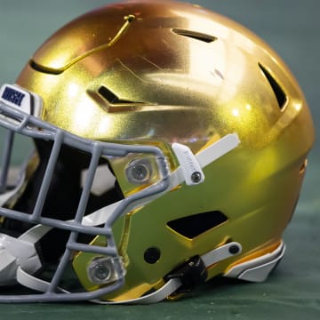 Jan 1, 2022; Glendale, Arizona, USA; Detailed view of a gold Notre Dame Fighting Irish helmet during the 2022 Fiesta Bowl at State Farm Stadium.