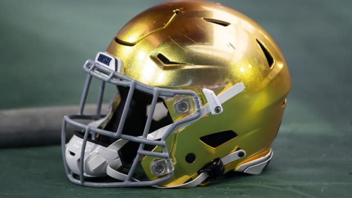 Jan 1, 2022; Glendale, Arizona, USA; Detailed view of a gold Notre Dame Fighting Irish helmet during the 2022 Fiesta Bowl at State Farm Stadium.