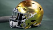 Jan 1, 2022; Glendale, Arizona, USA; Detailed view of a gold Notre Dame Fighting Irish helmet during the 2022 Fiesta Bowl at State Farm Stadium. 