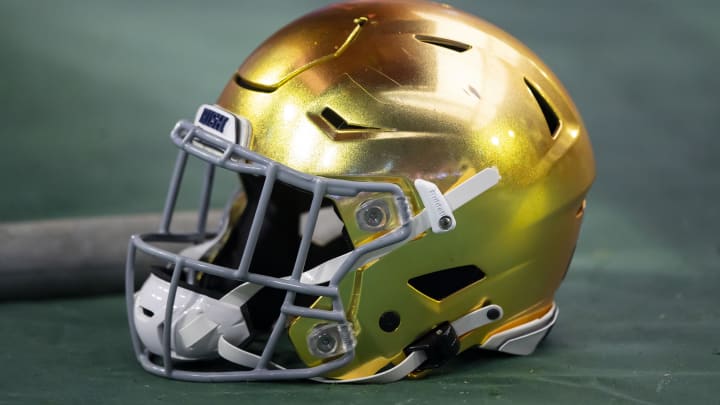 Jan 1, 2022; Glendale, Arizona, USA; Detailed view of a gold Notre Dame Fighting Irish helmet during the 2022 Fiesta Bowl at State Farm Stadium. 