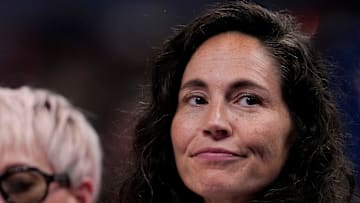 Megan Rapinoe (left) sits next to her wife, Sue Bird, on Friday, July 18, 2025, during the WNBA All-Star 3-point and skills contests at Gainbridge Fieldhouse in Indianapolis.