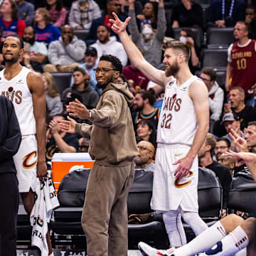 Nov 4, 2022; Detroit, Michigan, USA; Cleveland Cavaliers guard Darius Garland (10), forward Evan Mobley (4), guard Donovan Mitchell (45) and forward Dean Wade (32) celebrate a made 3-pointer by Cleveland Cavaliers forward Kevin Love (not pictured) against the Detroit Pistons in the second quarter at Little Caesars Arena. Mandatory Credit: Allison Farrand-Imagn Images
