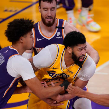 May 27, 2021; Los Angeles, California, USA; Los Angeles Lakers forward Anthony Davis (3) is surrounded by Phoenix Suns forward Cameron Johnson (23), forward Frank Kaminsky (8) and guard Cameron Payne (15) during the fourth quarter of game three in the first round of the 2021 NBA Playoffs at Staples Center. Mandatory Credit: Robert Hanashiro-USA TODAY Sports