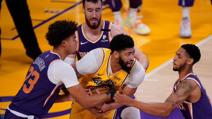 May 27, 2021; Los Angeles, California, USA; Los Angeles Lakers forward Anthony Davis (3) is surrounded by Phoenix Suns forward Cameron Johnson (23), forward Frank Kaminsky (8) and guard Cameron Payne (15) during the fourth quarter of game three in the first round of the 2021 NBA Playoffs at Staples Center. Mandatory Credit: Robert Hanashiro-USA TODAY Sports