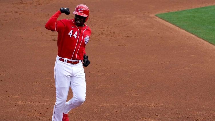 Cincinnati Reds outfielder Aristides Aquino (44) gestures as he rounds the bases after hitting a home run.