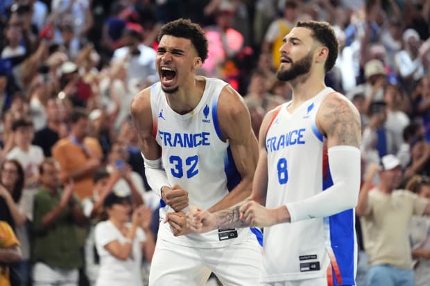 France power forward Victor Wembanyama (32) celebrates alongside shooting guard Isaia Cordinier (8). 