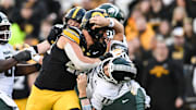 Nov 22, 2025; Iowa City, Iowa, USA; Iowa Hawkeyes defensive end Max Llewellyn (48) rushes Michigan State Spartans quarterback Alessio Milivojevic (11) during the second quarter at Kinnick Stadium. Mandatory Credit: Jeffrey Becker-Imagn Images