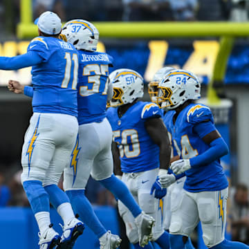 Aug 10, 2024; Inglewood, California, USA; Los Angeles Chargers safety Tony Jefferson (37) celebrates with quarterback Luis Perez (11) and other teammates after scoring a touchdown against the Seattle Seahawks during the third quarter at SoFi Stadium. Mandatory Credit: Jonathan Hui-Imagn Images