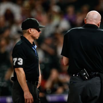 Jun 3, 2024; Denver, Colorado, USA; Cincinnati Reds manager David Bell (25) argues a call with home plate umpire Mike Estabrook (83) and first base umpire Tripp Gibson (73) in the eighth inning against the Colorado Rockies at Coors Field. Mandatory Credit: Isaiah J. Downing-USA TODAY Sports