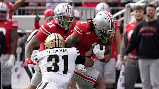 Ohio State Buckeyes running back Quinshon Judkins (1) is tackled by Purdue Boilermakers defensive back Dillon Thieneman (31)