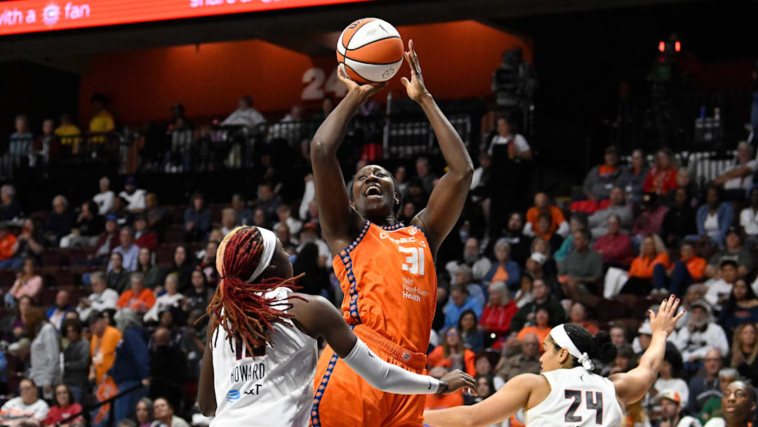 Sep 10, 2025; Uncasville, Connecticut, USA; Connecticut Sun center Tina Charles (31) shoots over Atlanta Dream guard Rhyne Howard (10) during the second half at Mohegan Sun Arena.