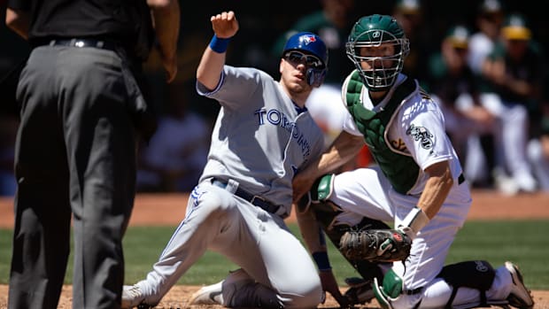 Oakland Athletics catcher Nick Hundley looks at the home plate umpire while wearing his catcher's gear