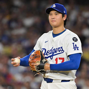 Sep 16, 2025; Los Angeles, California, USA; Los Angeles Dodgers two-way player Shohei Ohtani (17) smiles as he pitches to former teammate Philadelphia Phillies center fielder Brandon Marsh (16) during the fourth inning at Dodger Stadium. Mandatory Credit: Jayne Kamin-Oncea-Imagn Images