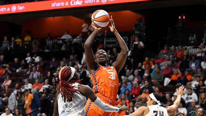 Sep 10, 2025; Uncasville, Connecticut, USA; Connecticut Sun center Tina Charles (31) shoots over Atlanta Dream guard Rhyne Howard (10) during the second half at Mohegan Sun Arena.