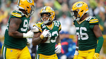 Green Bay Packers cornerback Jaire Alexander (23) celebrates recovering a fumble with teammates defensive end Karl Brooks (94) and linebacker Edgerrin Cooper (56) against the Arizona Cardinals during their football game Sunday, October 13, 2024, at Lambeau Field in Green Bay, Wisconsin.