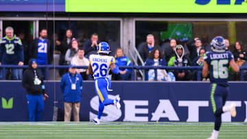 Nov 3, 2024; Seattle, Washington, USA; 
Los Angeles Rams safety Kamren Kinchens (26) scores a touchdown against the Seattle Seahawks after making an interception during the second half at Lumen Field. Mandatory Credit: Steven Bisig-Imagn Images