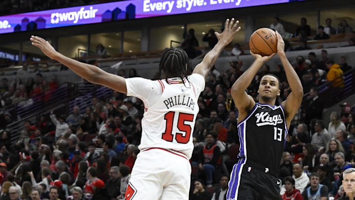 Jan 12, 2025; Chicago, Illinois, USA;  Chicago Bulls forward Julian Phillips (15) defends against Sacramento Kings forward Keegan Murray (13) 
