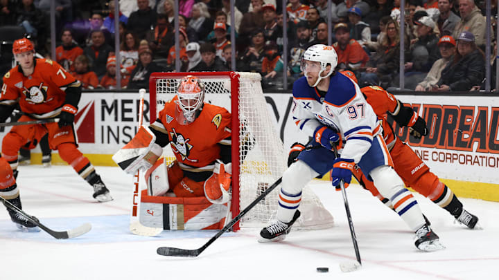 Feb 25, 2026; Anaheim, California, USA;  Edmonton Oilers center Connor McDavid (97) controls the puck as Anaheim Ducks goaltender Lukas Dostal (1) defends the goal during the first period at Honda Center. Mandatory Credit: Kiyoshi Mio-Imagn Images