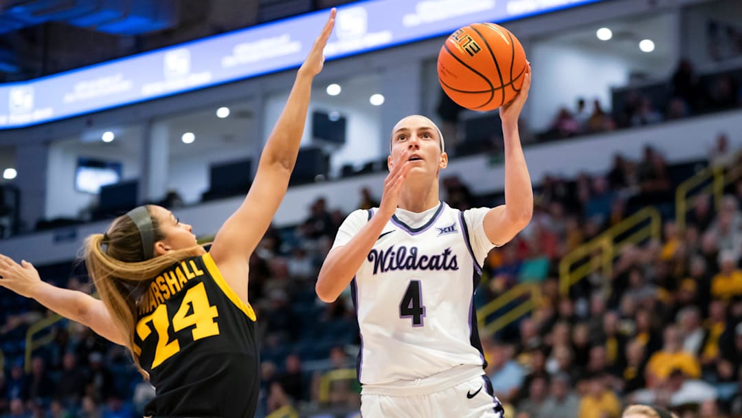 Kansas State Wildcats guard Serena Sundell (4) goes for a lay up while being guarded by Iowa Hawkeyes guard Gabbie Marshall (24) during the first quarter of the Gulf Coast Showcase championship game at Hertz Arena in Estero on Sunday, Nov. 26, 2023.