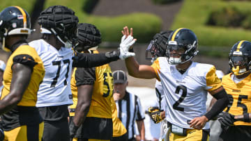 Jul 27, 2024; Latrobe, PA, USA; Pittsburgh Steelers quarterback Justin Fields celebrates with offensive tackle Broderick Jones (77) after scoring during training camp at Saint Vincent College. Mandatory Credit: Barry Reeger-USA TODAY Sports