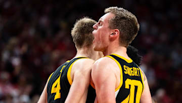 Mar 9, 2025; Lincoln, Nebraska, USA; Iowa Hawkeyes forward Payton Sandfort (20) and guard Josh Dix (4) celebrate during the second half against the Nebraska Cornhuskers at Pinnacle Bank Arena. Mandatory Credit: Dylan Widger-Imagn Images