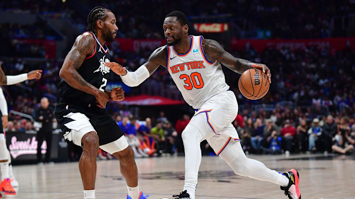 Dec 16, 2023; Los Angeles, California, USA; New York Knicks forward Julius Randle (30) moves the ball against Los Angeles Clippers forward Kawhi Leonard (2) during the second half at Crypto.com Arena. Mandatory Credit: Gary A. Vasquez-Imagn Images