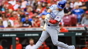 May 25, 2025; Cincinnati, Ohio, USA; Chicago Cubs catcher Reese McGuire (20) hits a solo home run in the second inning against the Cincinnati Reds at Great American Ball Park.
