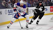 Apr 29, 2025; Los Angeles, California, USA; Edmonton Oilers center Leon Draisaitl (29) moves the puck against Los Angeles Kings defenseman Vladislav Gavrikov (84) during the first period in game five of the first round of the 2025 Stanley Cup Playoffs at Crypto.com Arena. Mandatory Credit: Gary A. Vasquez-Imagn Images