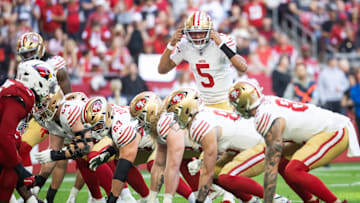 Jan 5, 2025; Glendale, Arizona, USA; San Francisco 49ers quarterback Joshua Dobbs (5) calls a play against the Arizona Cardinals in the first half at State Farm Stadium. Mandatory Credit: Mark J. Rebilas-Imagn Images