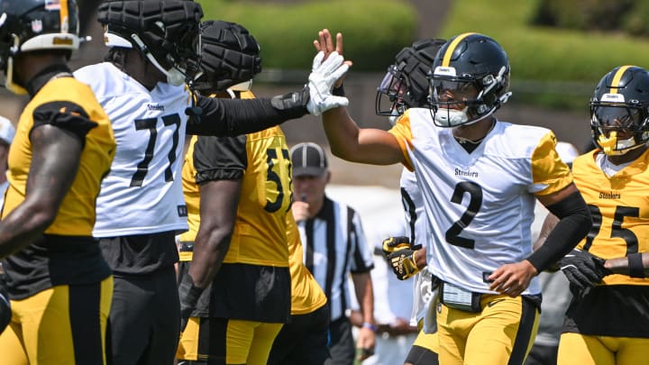 Jul 27, 2024; Latrobe, PA, USA; Pittsburgh Steelers quarterback Justin Fields celebrates with offensive tackle Broderick Jones (77) after scoring during training camp at Saint Vincent College. Mandatory Credit: Barry Reeger-USA TODAY Sports