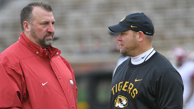 Arkansas Razorbacks head coach Bret Bielema talks with Missouri Tigers head coach Barry Odom 