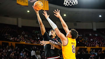 Mar 8, 2025; Tempe, Arizona, USA; Texas Tech Red Raiders forward JJ Topin (15) goes for a layup against Arizona State Sun Devils forward Basheer Jihad (8) during the first half at Desert Financial Arena. Mandatory Credit: Arianna Grainey-Imagn Images