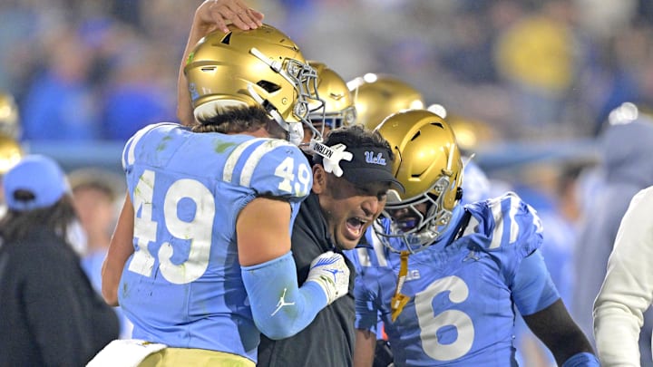 Nov 8, 2024; Pasadena, California, USA; UCLA Bruins defensive coordinator Ikaika Malloe, center, celebrates with linebacker Carson Schwesinger (49) defensive back Jaylin Davies (6) after an interception in the second half against the Iowa Hawkeyes at the Rose Bowl. Mandatory Credit: Jayne Kamin-Oncea-Imagn Images Nov 8, 2024; Pasadena, California, USA; UCLA Bruins defensive coordinator Ikaika Malloe, center, celebrates with linebacker Carson Schwesinger (49) defensive back Jaylin Davies (6) after an interception in the second half against the Iowa Hawkeyes at the Rose Bowl. Mandatory Credit: Jayne Kamin-Oncea-Imagn Images