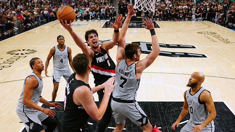 Portland Trail Blazers forward Deni Avdija drives to the hoop between San Antonio Spurs Carter Bryant and Luke Kornet.