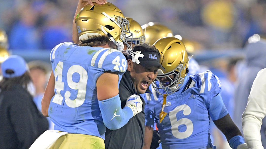 Nov 8, 2024; Pasadena, California, USA;   UCLA Bruins defensive coordinator Ikaika Malloe, center, celebrates with linebacker Carson Schwesinger (49) defensive back Jaylin Davies (6) after an interception in the second half against the Iowa Hawkeyes at the Rose Bowl. Mandatory Credit: Jayne Kamin-Oncea-Imagn Images
