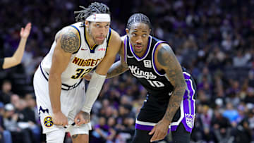Dec 16, 2024; Sacramento, California, USA; Denver Nuggets forward Aaron Gordon (32) and Sacramento Kings forward DeMar DeRozan (10) during the second quarter at Golden 1 Center. Mandatory Credit: Sergio Estrada-Imagn Images