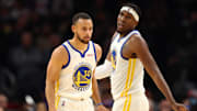 Nov 30, 2021; Phoenix, Arizona, USA; Golden State Warriors guard Stephen Curry (30) and center Kevon Looney (5) against the Phoenix Suns at Footprint Center. Mandatory Credit: Mark J. Rebilas-Imagn Images