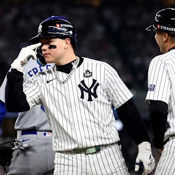 New York, New York, USA; New York Yankees outfielder Alex Verdugo (24) celebrates with first base coach Travis Chapman (75) after hitting a RBI single during the second inning against the Los Angeles Dodgers in Game 5 of the 2024 MLB World Series at Yankee Stadium.