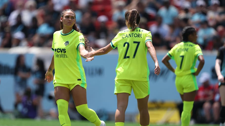 Washington Spirit forward Trinity Rodman slaps hands with forward Sofia Cantore 