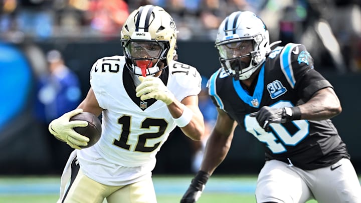 Nov 3, 2024; Charlotte, North Carolina, USA; New Orleans Saints wide receiver Chris Olave (12) with the ball as Carolina Panthers linebacker Charles Harris (40) defends in the first quarter at Bank of America Stadium. Mandatory Credit: Bob Donnan-Imagn Images
Nov 3, 2024; Charlotte, North Carolina, USA; New Orleans Saints wide receiver Chris Olave (12) with the ball as Carolina Panthers linebacker Charles Harris (40) defends in the first quarter at Bank of America Stadium. Mandatory Credit: Bob Donnan-Imagn Images