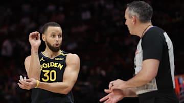 Feb 13, 2025; Houston, Texas, USA;  Golden State Warriors guard Stephen Curry (30) talks to official Brett Nansel in the first half against the Houston Rockets at Toyota Center. Mandatory Credit: Thomas Shea-Imagn Images