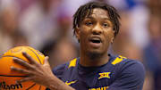 West Virginia super-senior Kedrian Johnson (0) yells to a teammate after a possession change during the first half of Saturday   s game against Kansas inside Allen Fieldhouse.