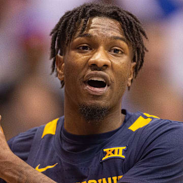 West Virginia super-senior Kedrian Johnson (0) yells to a teammate after a possession change during the first half of Saturday   s game against Kansas inside Allen Fieldhouse.